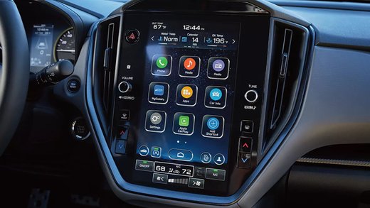 Close-up of a Subaru dashboard with a vertical touchscreen infotainment display and climate controls.
