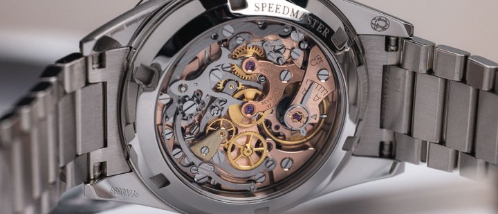 Exhibition case-back view of an Omega Speedmaster chronograph movement and bracelet