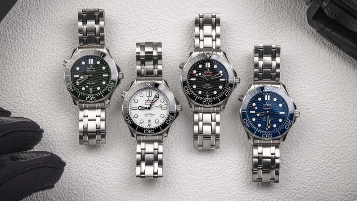 Four Omega Seamaster Professional 300M watches arranged on a light surface